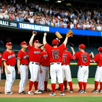 **David vs. Goliath Baseball:** A dynamic action shot of a small, scrappy baseball team (uniforms representing a lesser-known baseball nation) triumphantly celebrating a win against a much larger, imposing team (uniforms representing a baseball powerhouse) in a packed stadium. Focus on the underdog team's joyous expressions and the shocked faces of the favored team. Include elements that suggest international competition, such as flags and diverse fans.
